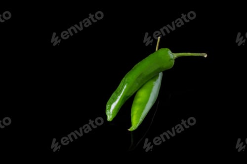 Preview: Green peppers on black background.
