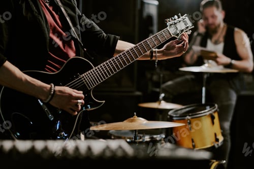 Preview: Musicians Rehearsing with Guitar and Drums at Night