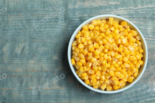Preview: Tasty canned sweet corn on blue wooden table, top view