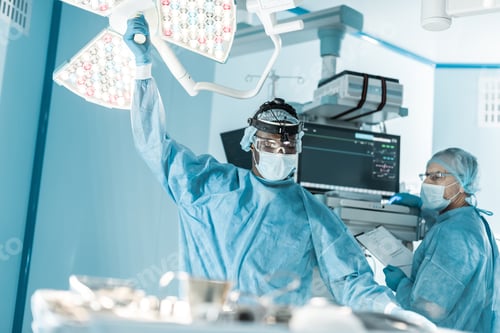 Preview: african american doctor setting surgical light