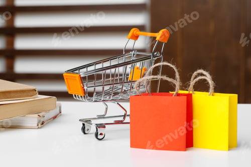 Preview: Small shopping cart with paper bags. Close up.