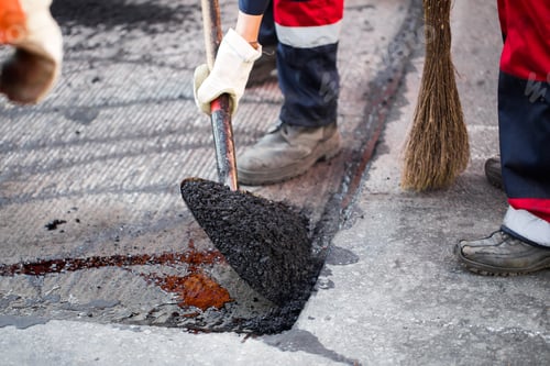 Preview: Young builder on Asphalting paver machine during Road street repairing works