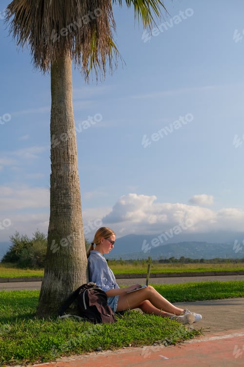 Preview: Remote work.Girl freelancer works remotely on the sea shore.workation, remote work,WFVH,Van Life vib