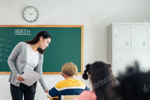 Preview: Group of student learn with teacher in classroom at elementary school.