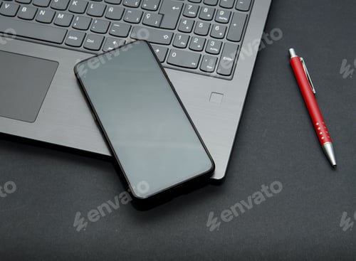 Preview: Laptop with smart phone, glasses and pen for working