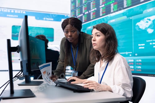 Preview: Diverse team of analysts examining monthly cost and revenue elements
