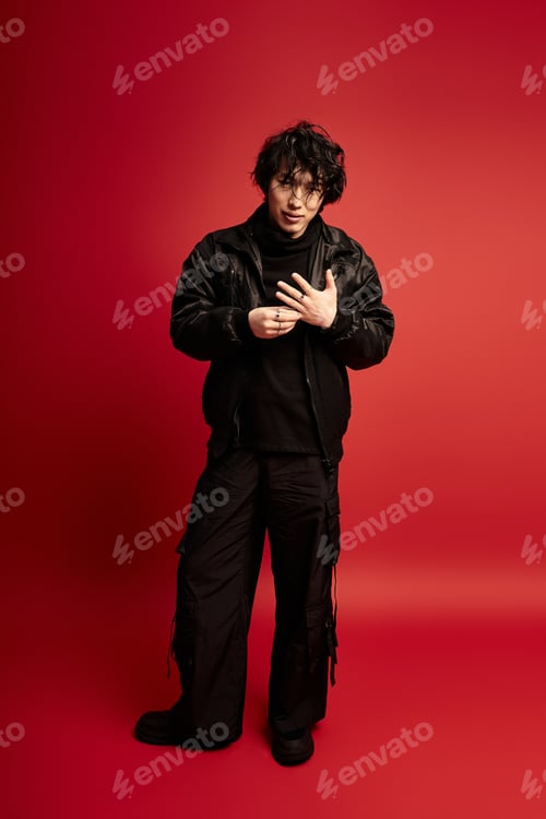 Preview: Urban poise asian model showcases modern streetwear in studio setting