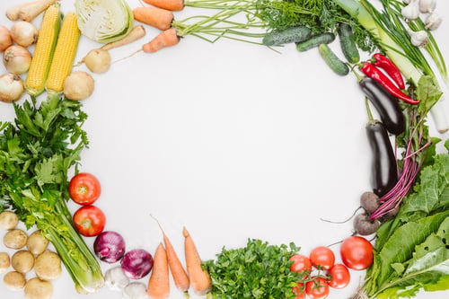 Preview: flat lay with fresh autumn vegetables arranged with blank space in middle isolated on white