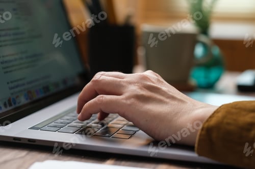 Preview: close up hand typing on laptop keyboard when woking at home