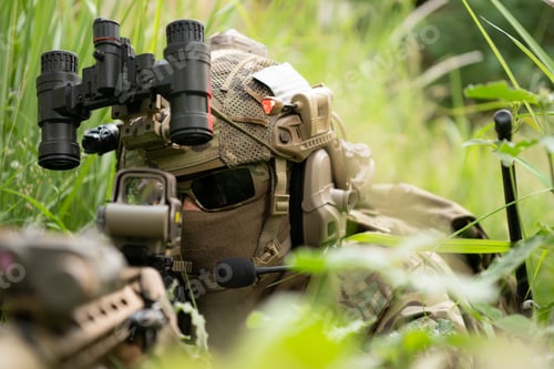 Preview: Special forces soldier in camouflage with a pair of weapons that are full of modern technology