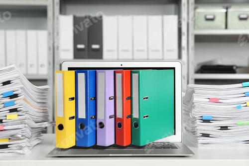 Preview: Digital archive. Laptop with folders sticking out of screen in office