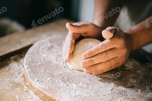 Preview: Man kneading and baking homemade pizza dough in the kitchen.