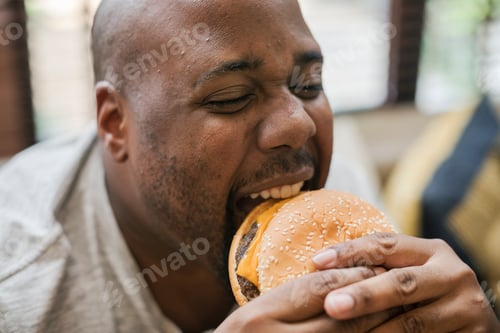 Preview: Man eating a big hamburger
