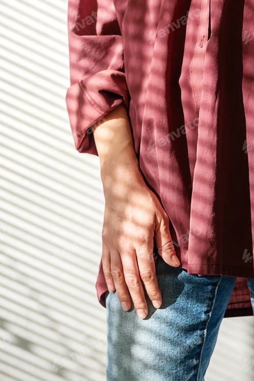 Preview: Woman in Fashionable Burgundy Shirt and Casual Jeans Enjoying Bright Sunlight in Modern House.