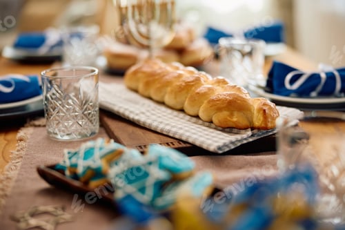 Preview: Traditional Challah bread on dining table for Hanukkah.