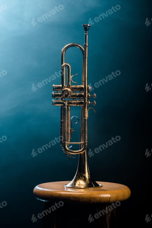 Preview: studio shot of trumpet on chair with dramatic lighting background