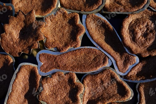 Preview: High angle view on baking tray with Christmas cocoa cookies in forms.