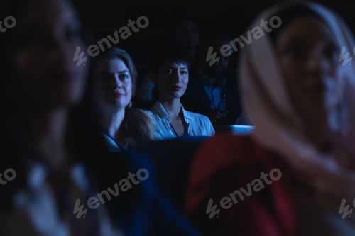 Preview: Beautiful Asian businesswoman holding laptop and listening to the presentation in auditorium