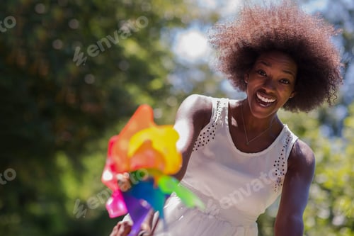 Preview: pretty young african american woman riding a bike in forest