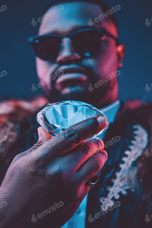 Preview: Rich african man with fur holding luxurious diamond