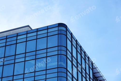 Preview: modern glass facade office building against blue sky
