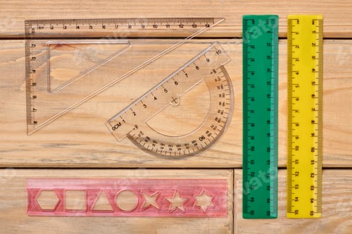 Preview: Various plastic rulers on wooden background.