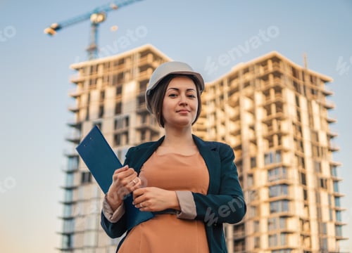 Preview: beatiful business woman engineer is standing with plan papers
