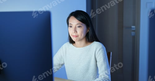 Preview: Woman work on computer at night