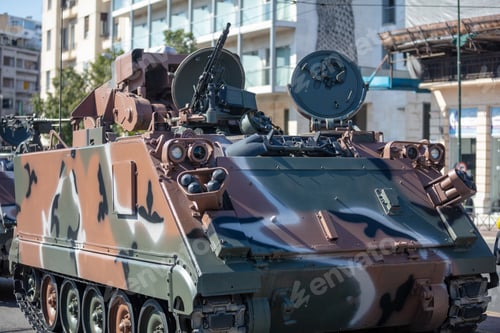 Preview: M113 armored personnel carrier, APC. Military parade. War weapon, camouflage vehicle, close up.