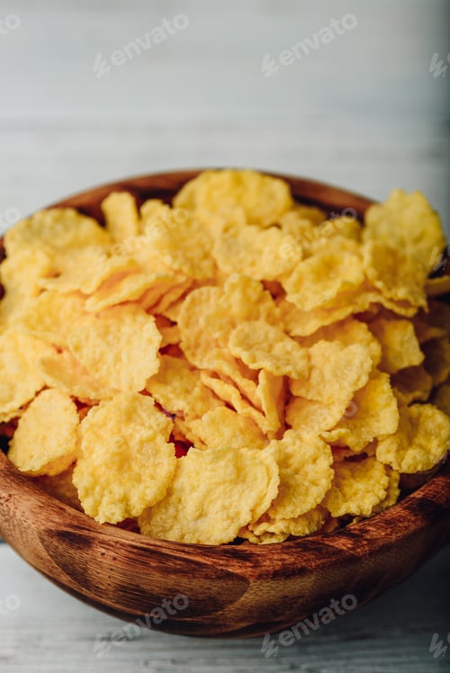 Preview: Breakfast cornflakes in a wooden bowl