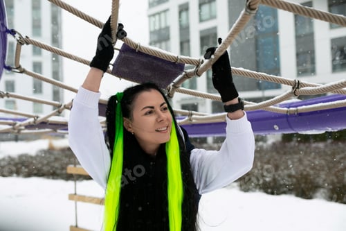 Preview: Woman Holding Onto Rope in Snow