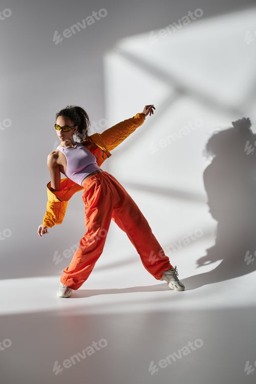 Preview: Stylish woman poses in studio with sunshine