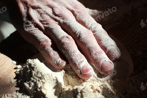 Preview: older woman kneading dough close-up