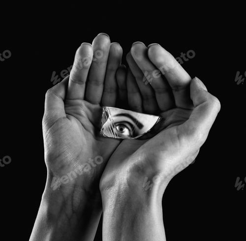 Preview: two hands holding a container with an object in it on a black background
