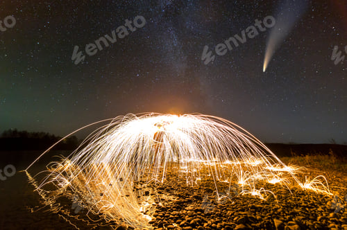 Preview: Long exposure of spinning steel wool in abstract circle making firework showers