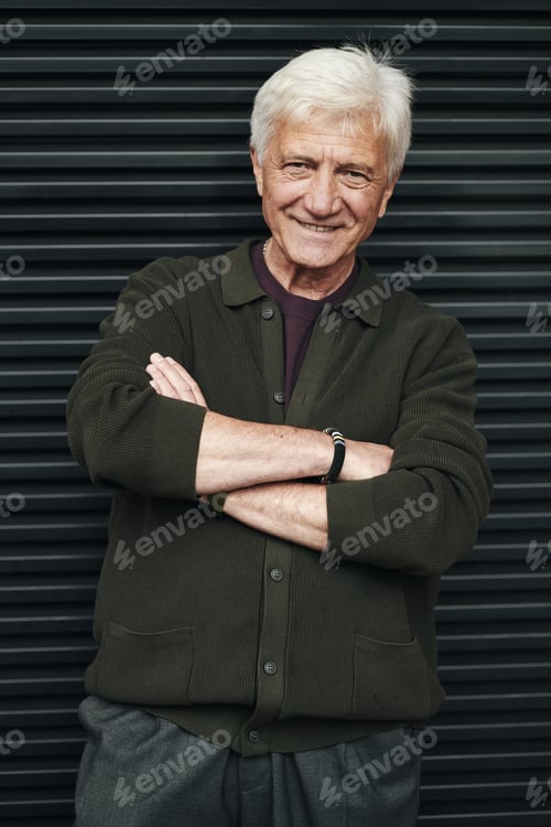 Preview: Portrait of Senior Man Smiling with Arms Crossed Outdoors