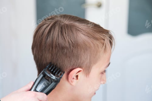 Preview: Blond boy gets haircut at home.