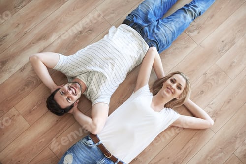 Preview: Couple with hands behind head laying on the floor