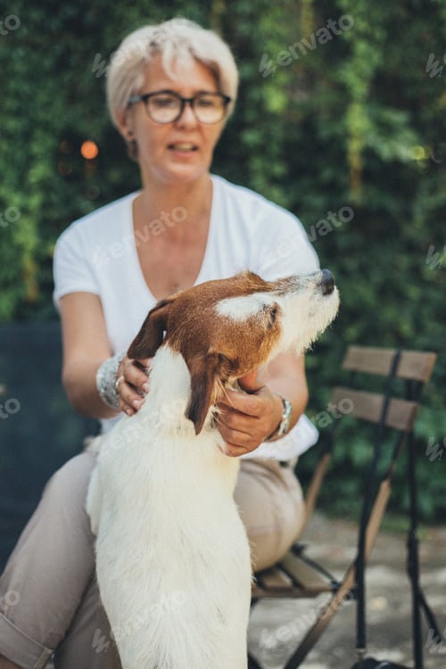 Preview: Woman Cuddles Her Dog Outdoors in Natural Light