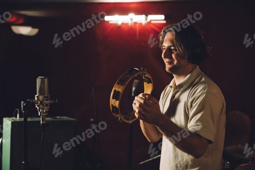 Preview: Musician playing a tambourine during a recording session