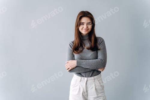 Preview: Portrait of a beautiful young woman on a gray background with copy space.