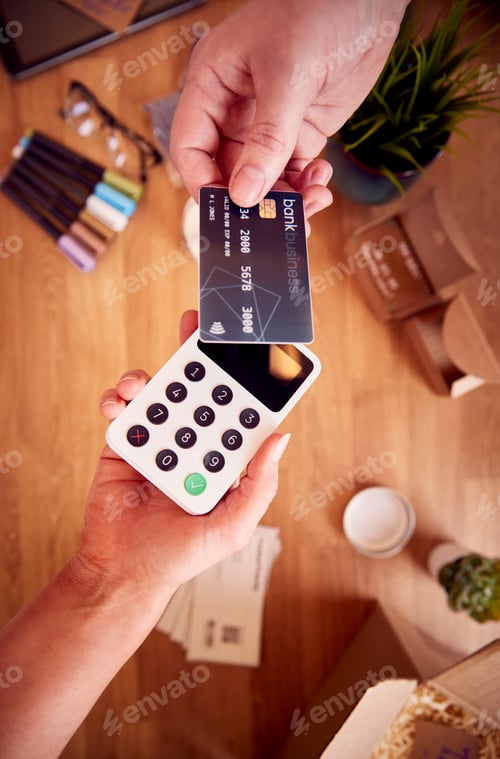 Preview: Overhead Shot Of Contactless Card Payment Being Taken From Bank Card For Handmade Candles