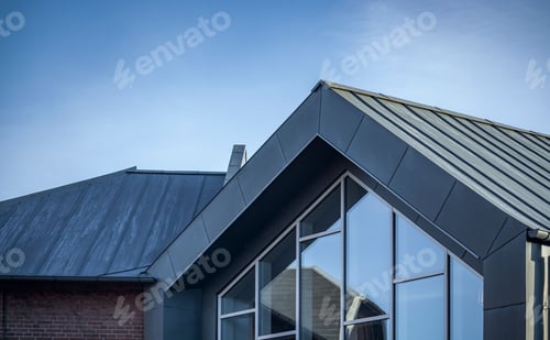 Preview: Modern building with glass windows against a blue sky