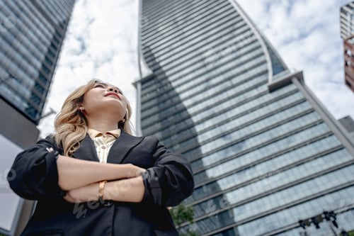 Preview: Professional woman working on her laptop in a dynamic cityscape
