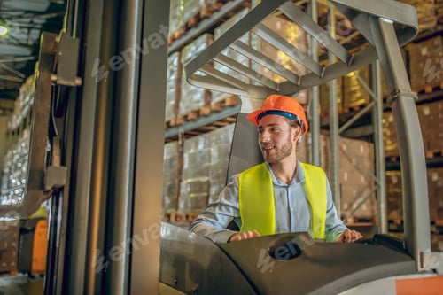 Preview: Busy Day. Young Bearded Worker Standing In The Aisle And Looking Concentrated