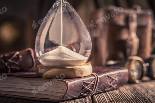 Preview: Vintage hourglass and journal with compass and binocular