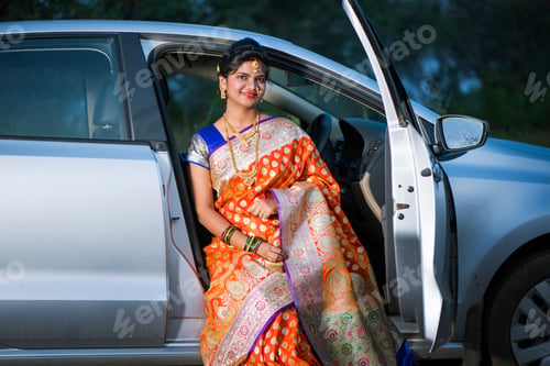 Preview: Beautiful Indian bride sitting in a car.