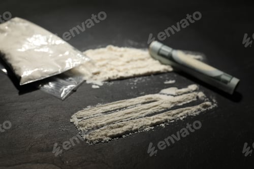 Preview: Drug addiction. Plastic bag with cocaine and rolled dollar banknote on grey textured table, closeup