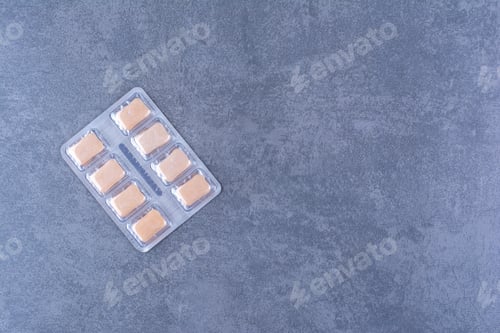 Preview: A pack of yellow gum tablets on marble background