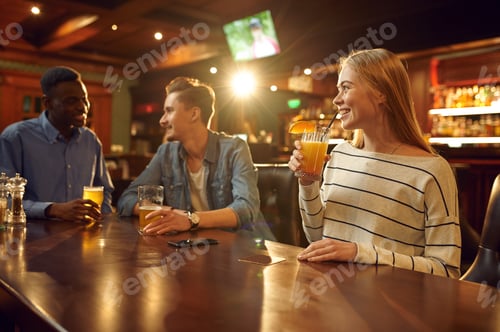 Preview: Friends with alcohol beverages having fun in bar